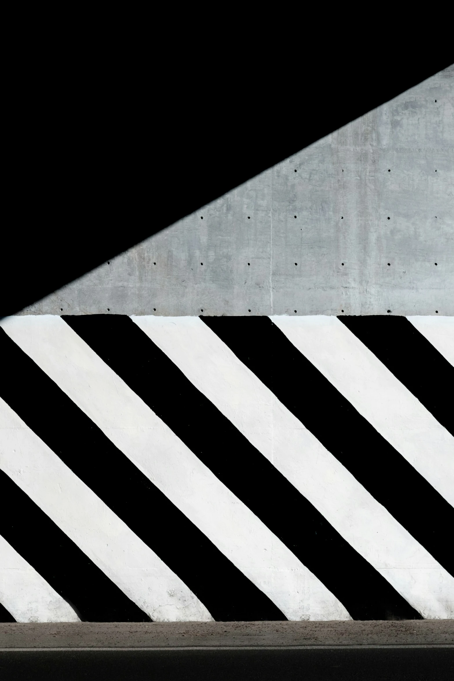 a man on a skateboard next to black and white stripes