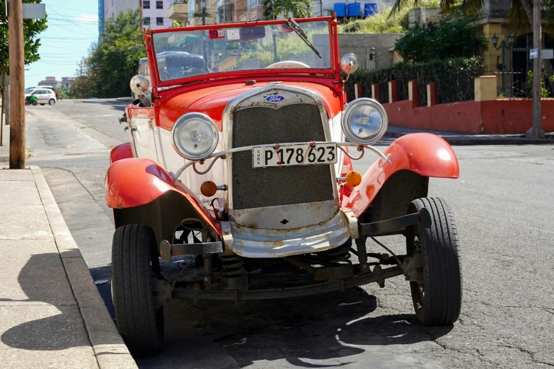 an old classic style car is parked along the side of the road