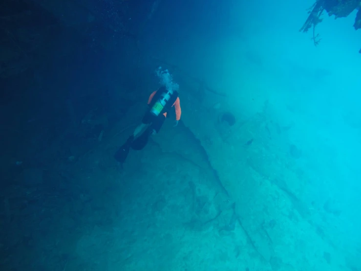 a man in a wetsuit floating in the ocean