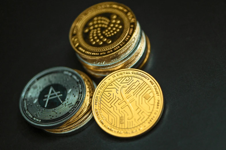 a pile of coins on a black table