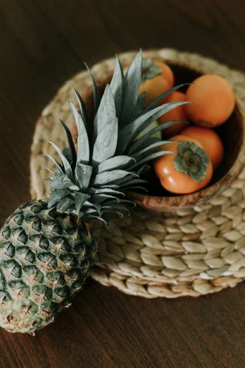 a wooden table with a basket and pineapple