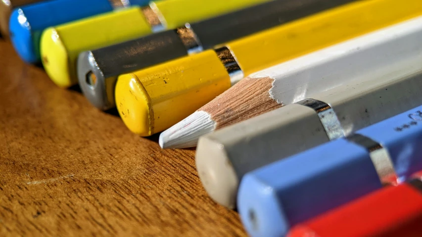 some colorful crayons are on a wood table