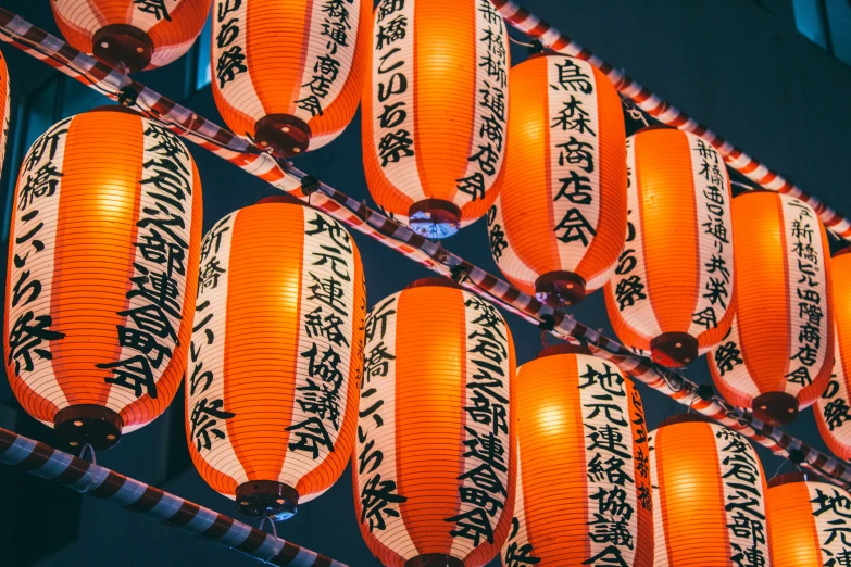 chinese lanterns with different symbols on the sides