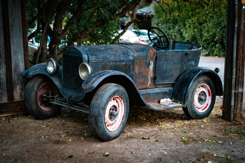 an old antique ford coupe truck on dirt