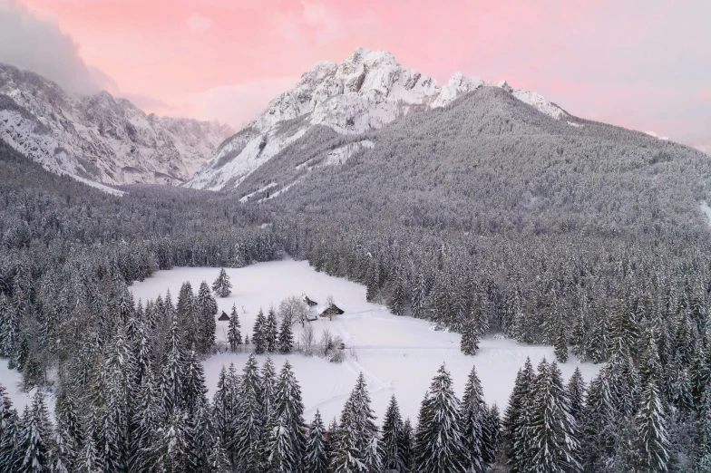 a snow covered mountain range in the foreground with snow piled up on top