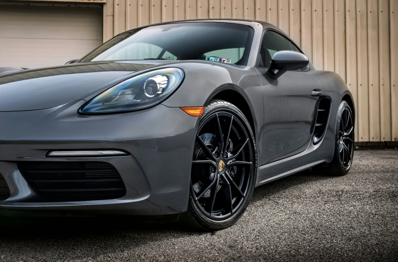 the back end of a grey porsche car