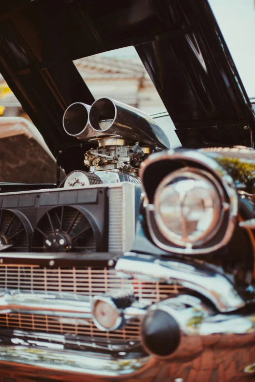 an antique car with radiator, exhaust and hood open