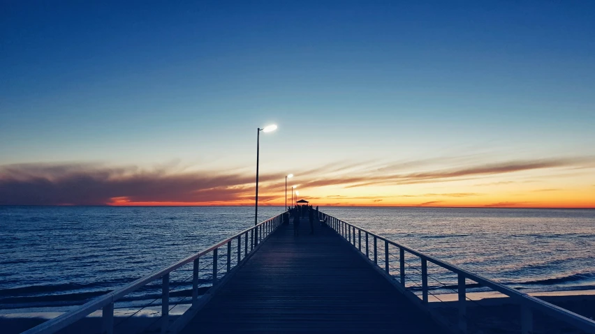 a pier with light poles along the end of it