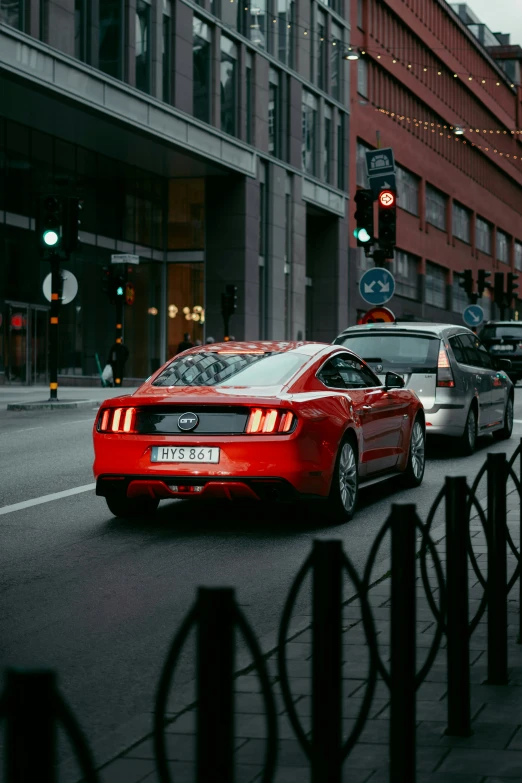 a red car waiting at a traffic light