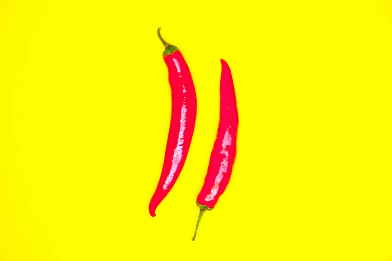 two  peppers on a yellow background