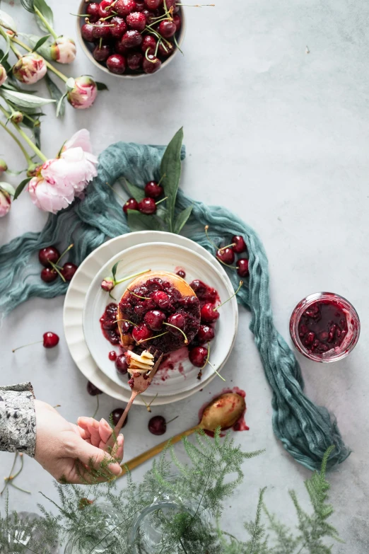 an aerial po shows cranberry sauce being poured over cranberries on a plate