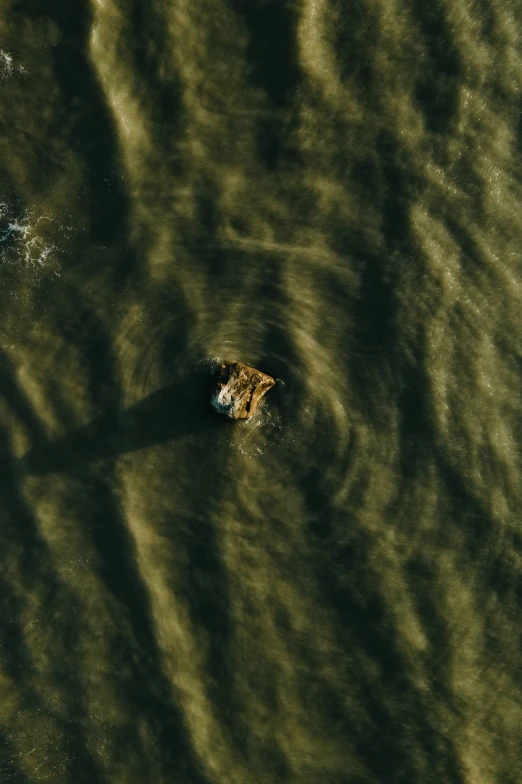 a boat floating down the ocean next to shore