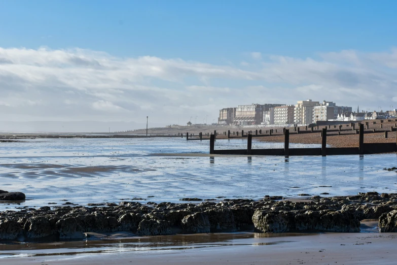 the coast is covered in water with a wooden dock