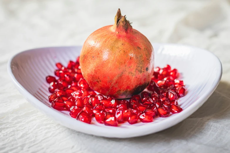 the pomegranate on the plate is ready to eat