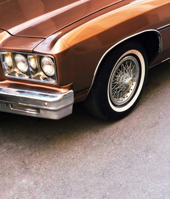 an older - fashioned car is parked along the street