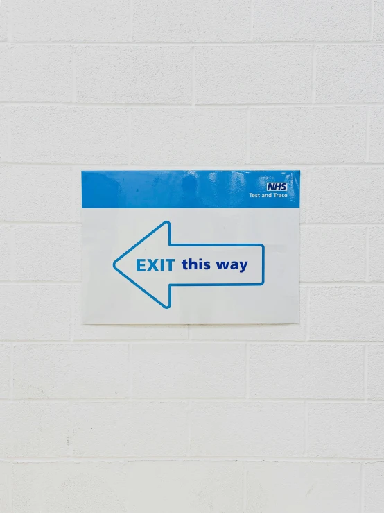 exit sign with arrow pointing towards a building