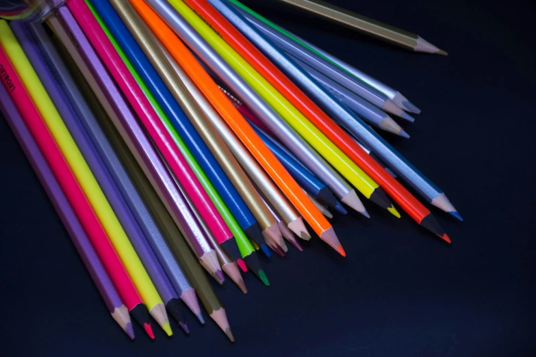 several different colored pencils with long end tops