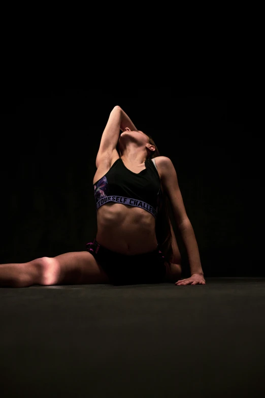 a woman doing the splits on her stomach