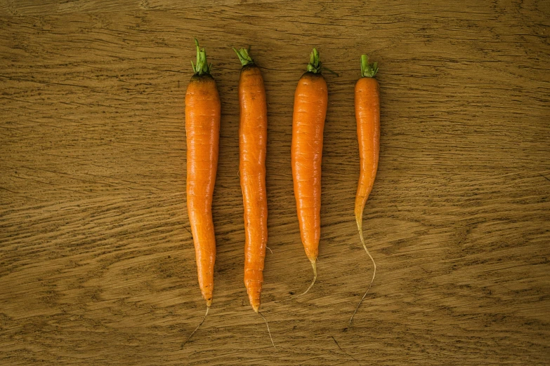 some very bright orange carrots on a table