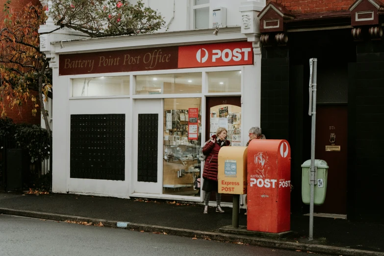 the front of a post office with some signs