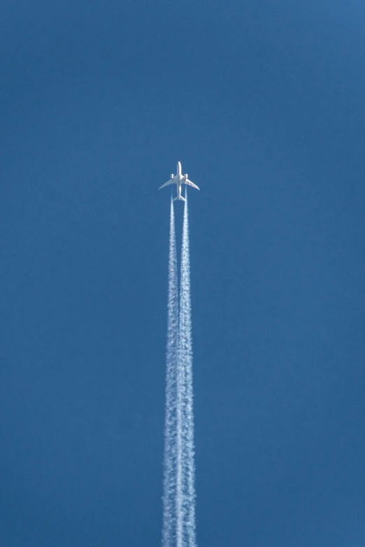 there is a jet airplane leaving a trail in the air