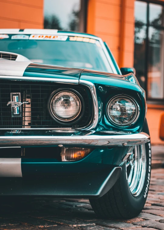 a blue mustang sits parked near a store