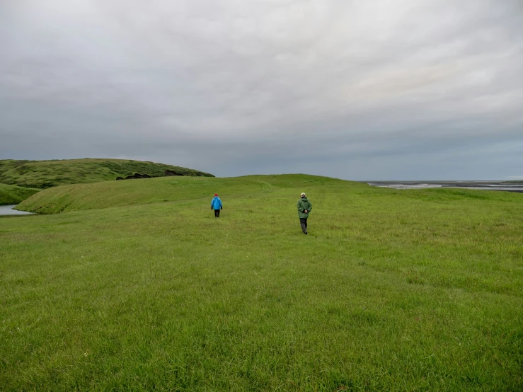 a couple of people in a field near one another