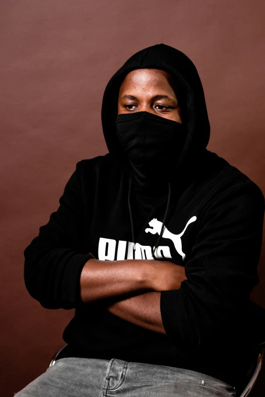 a man wearing a hoodie and looking into the camera