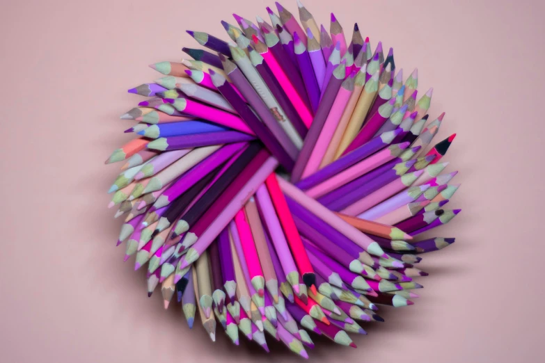 an art object with multiple colored pencils arranged in the shape of a flower