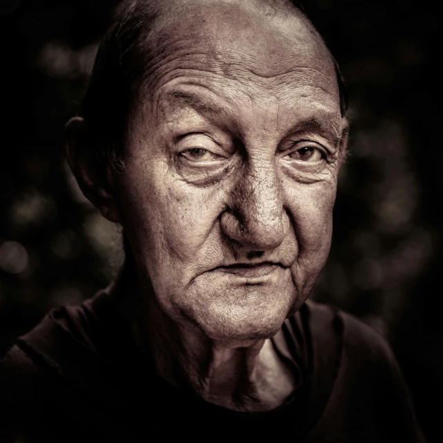a older man with wrinkles looks to his left
