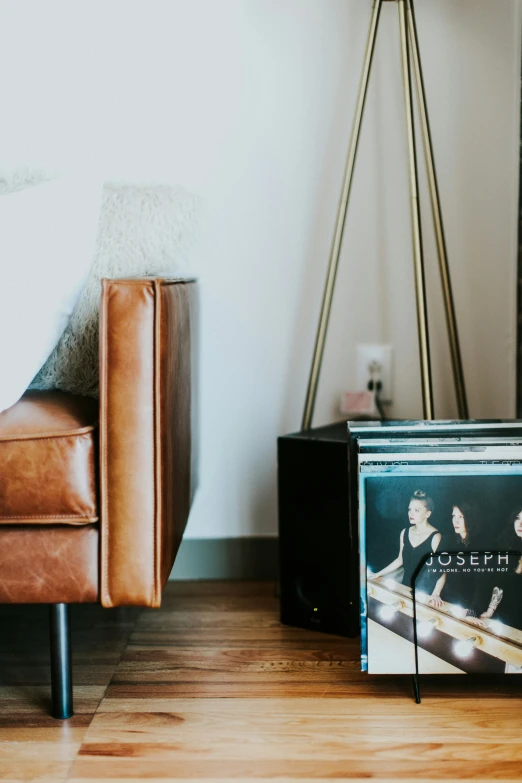 a couch and an open dvd player are pictured