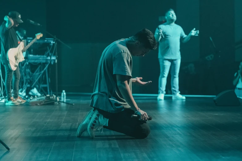 a man sitting on the floor with music instruments