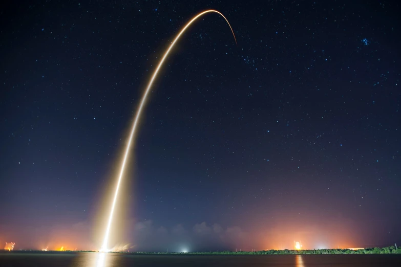 a rocket lifts off from the ground at night