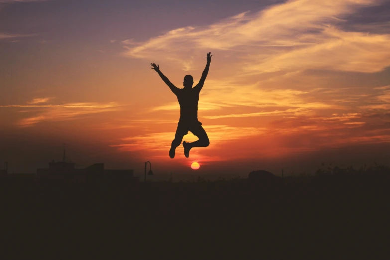 man performing trick for camera at sunset