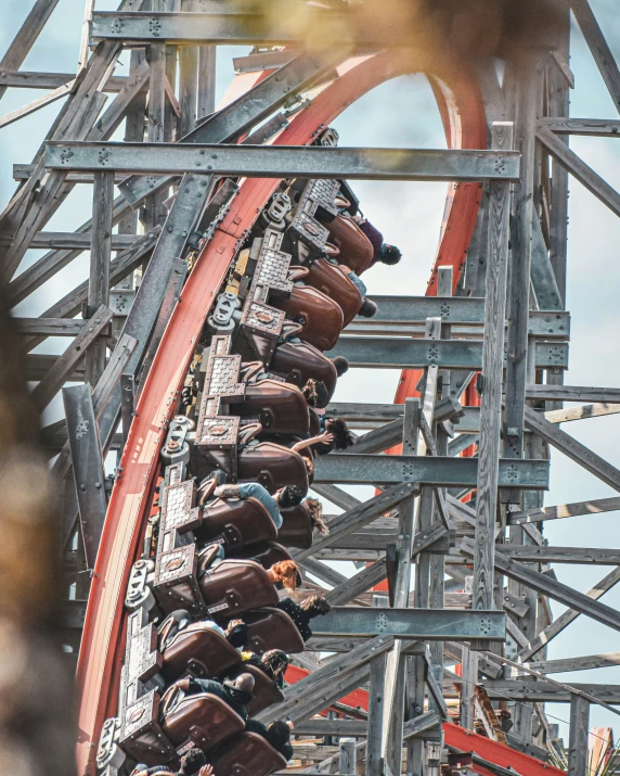 a roller coaster going up a track that has many people on it