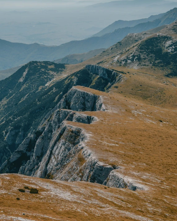 a view from the top of a mountain, with mountains in the background