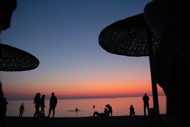 silhouettes and people at the beach during sunset