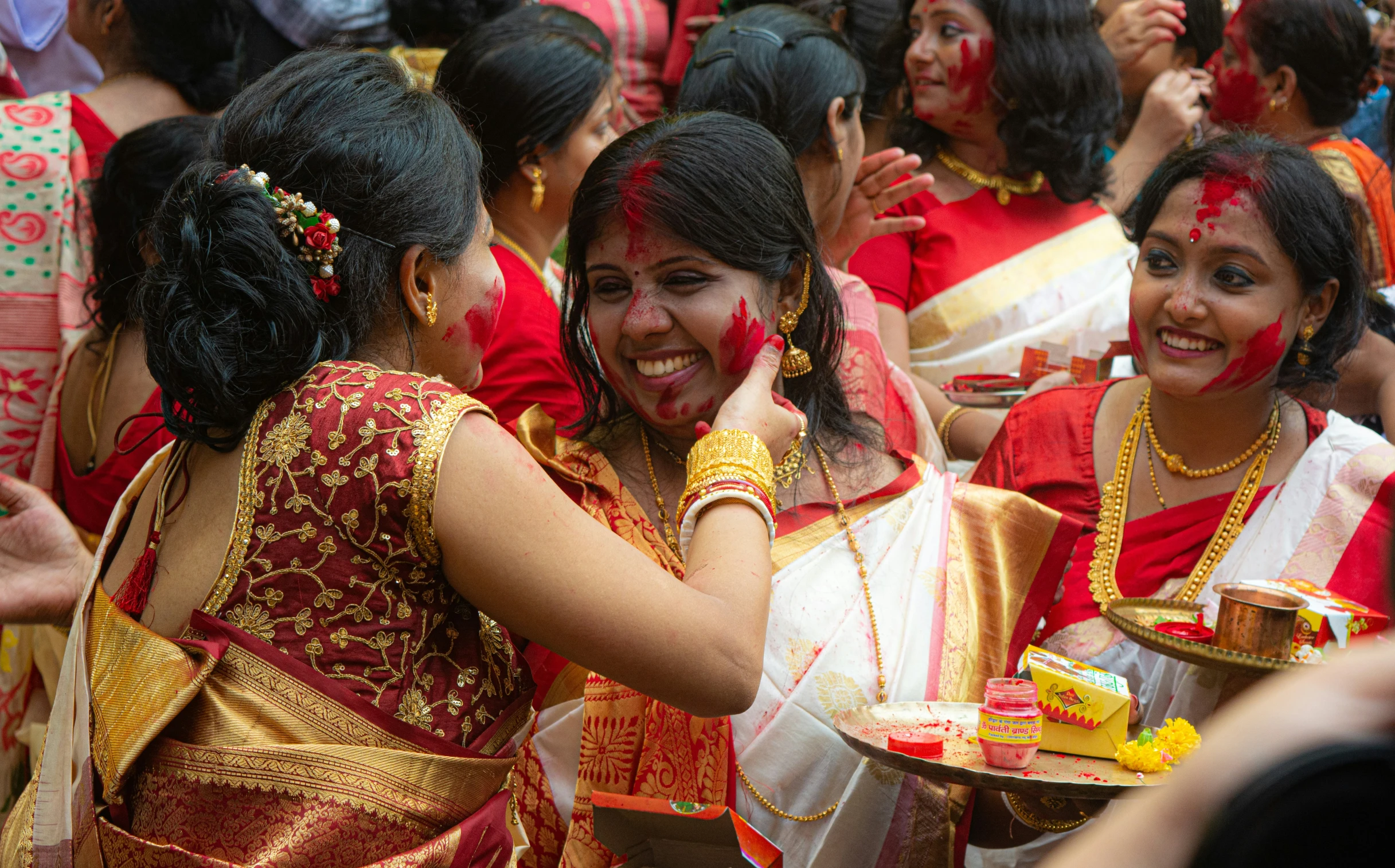 many women are getting and having their face painted in colorful