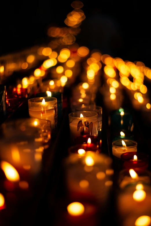 many lit candles that have been placed on a table