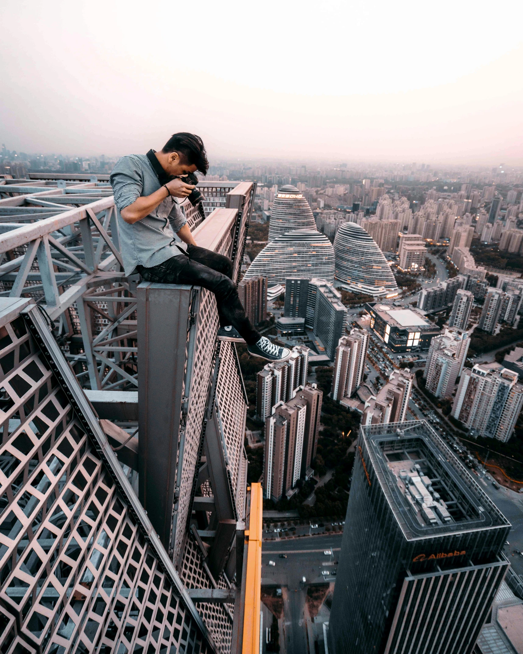 an image of a man that is leaning over the side of a building