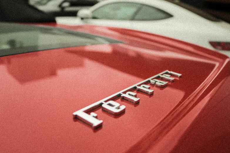 the emblem on the rear of a red sports car