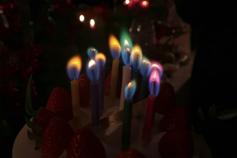colorful candles are arranged around the cake