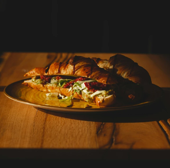 a plate of food on a table with dark shadows