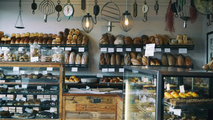 an assortment of pastries and loaves displayed on shelves