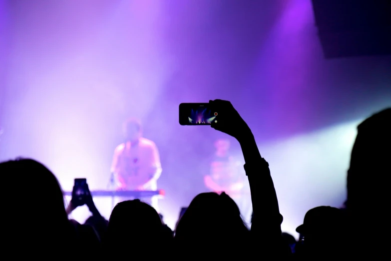 a group of people are in the dark with their cell phones