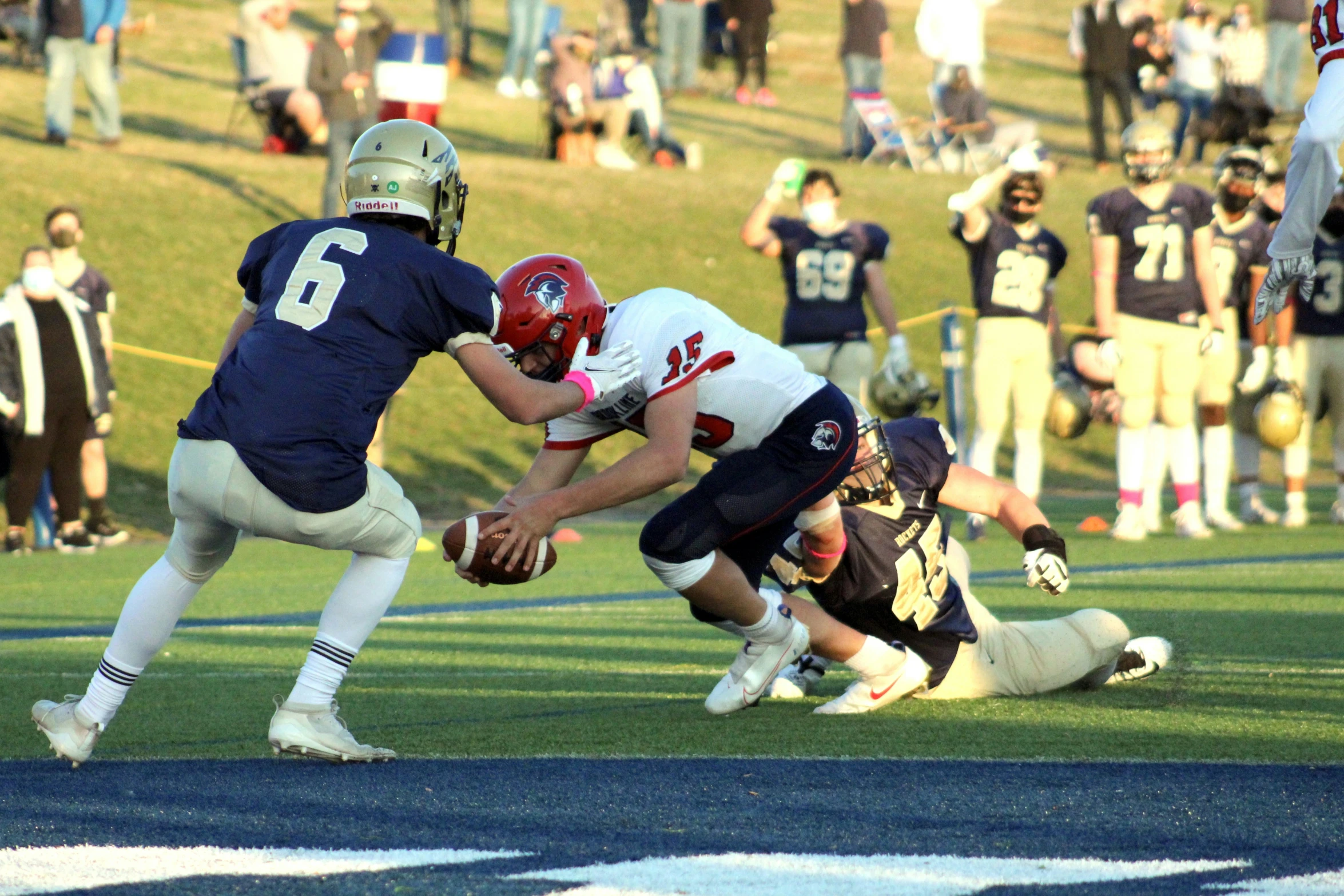 two football players in action while a crowd watches