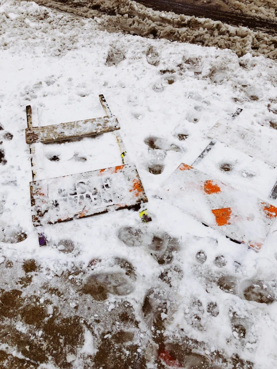 the ground with some orange and white snow