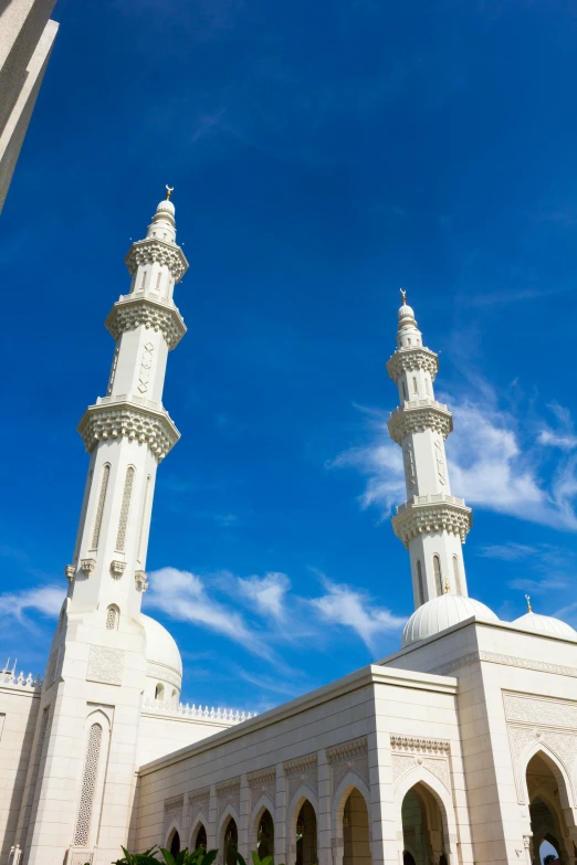 an arabic mosque in the middle of a blue sky