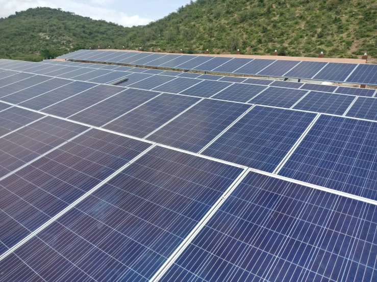 several rows of solar panels in a field