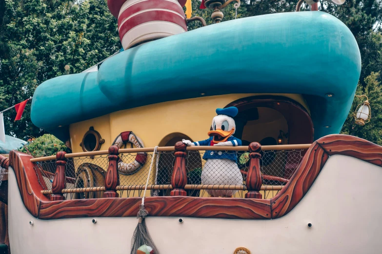 a disney duck float with one stuffed animal at the top